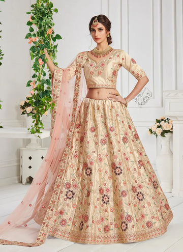 Elegant beige silk lehenga choli with heavy zari, thread embroidery, velvet patch, and zarkan work.