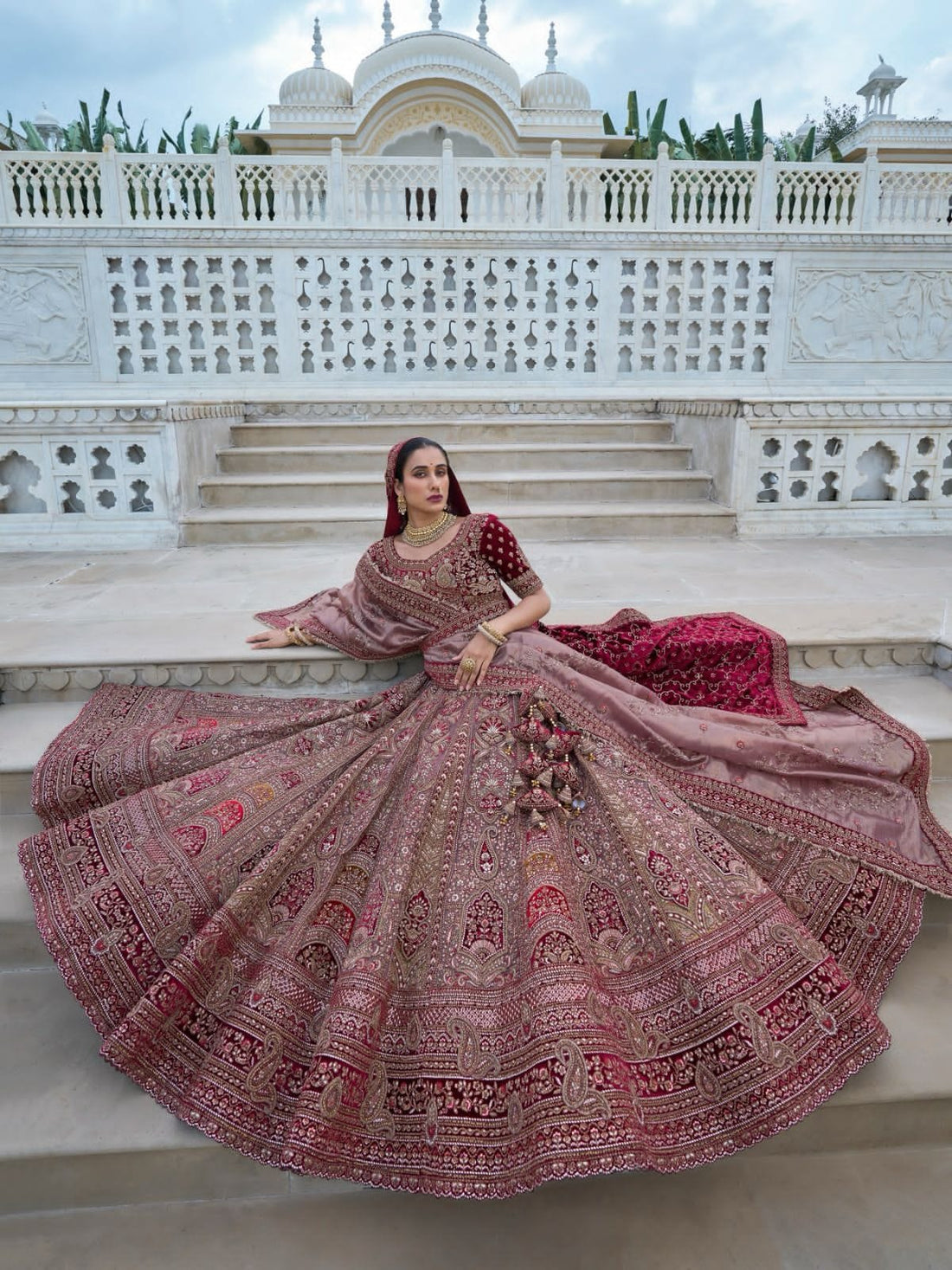 Elegant maroon and beige bridal lehenga choli with intricate embroidery.

