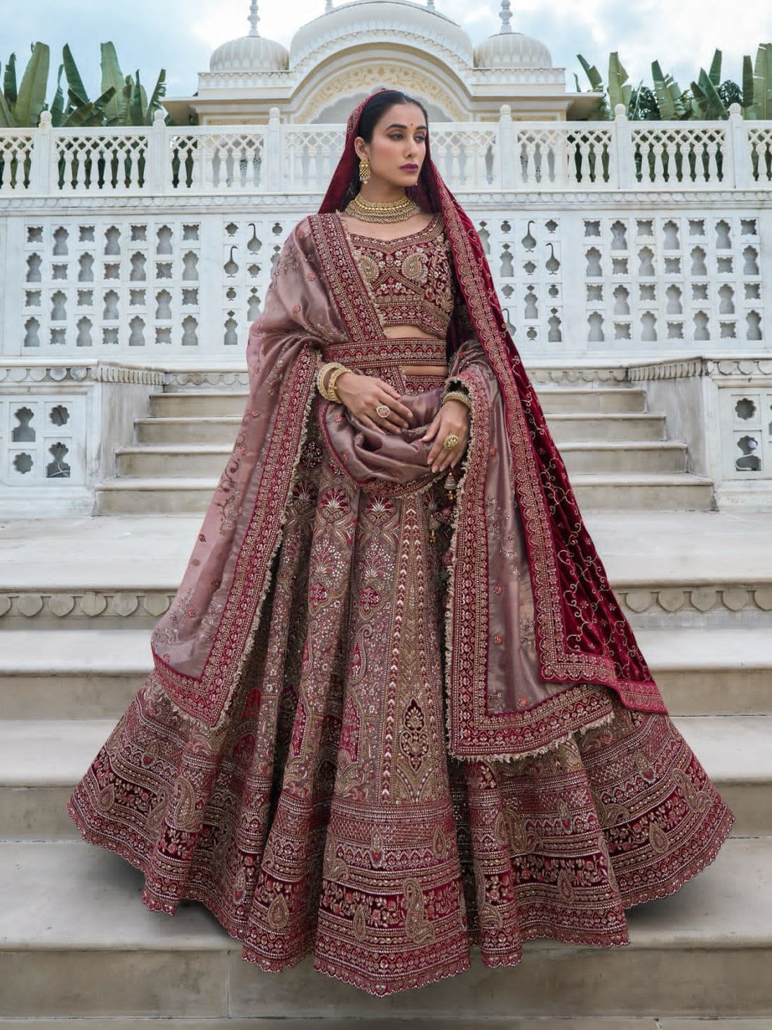 Elegant maroon and beige bridal lehenga choli with intricate embroidery.

