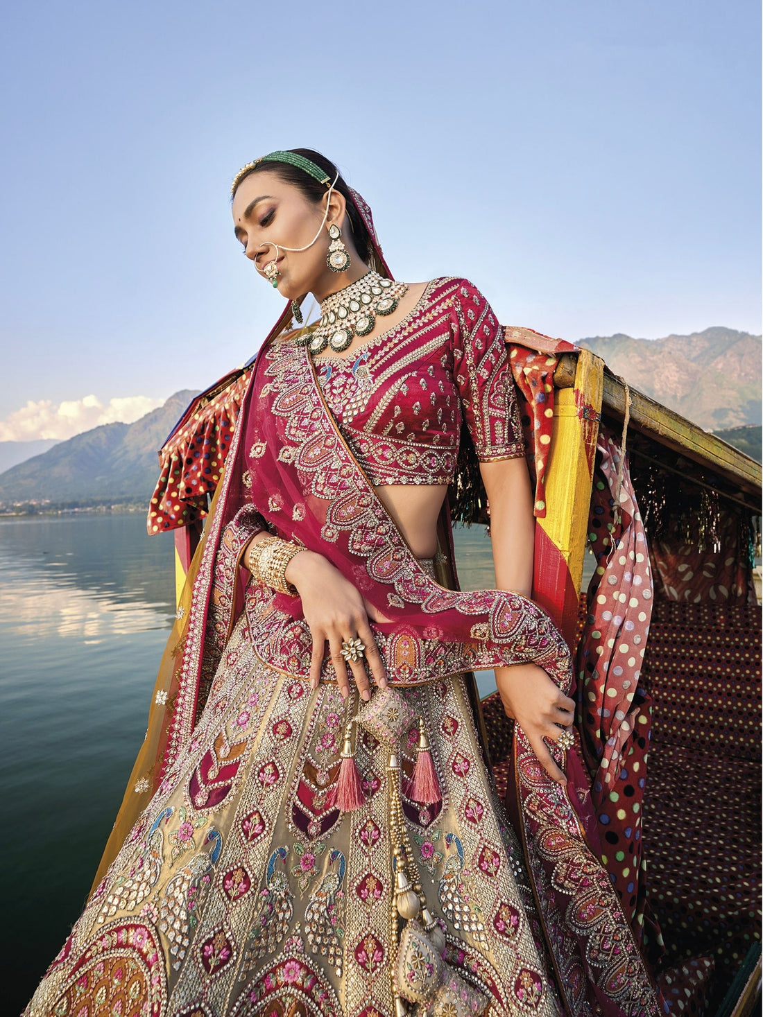 Elegant gold silk bridal lehenga with maroon embroidered blouse and dupatta.