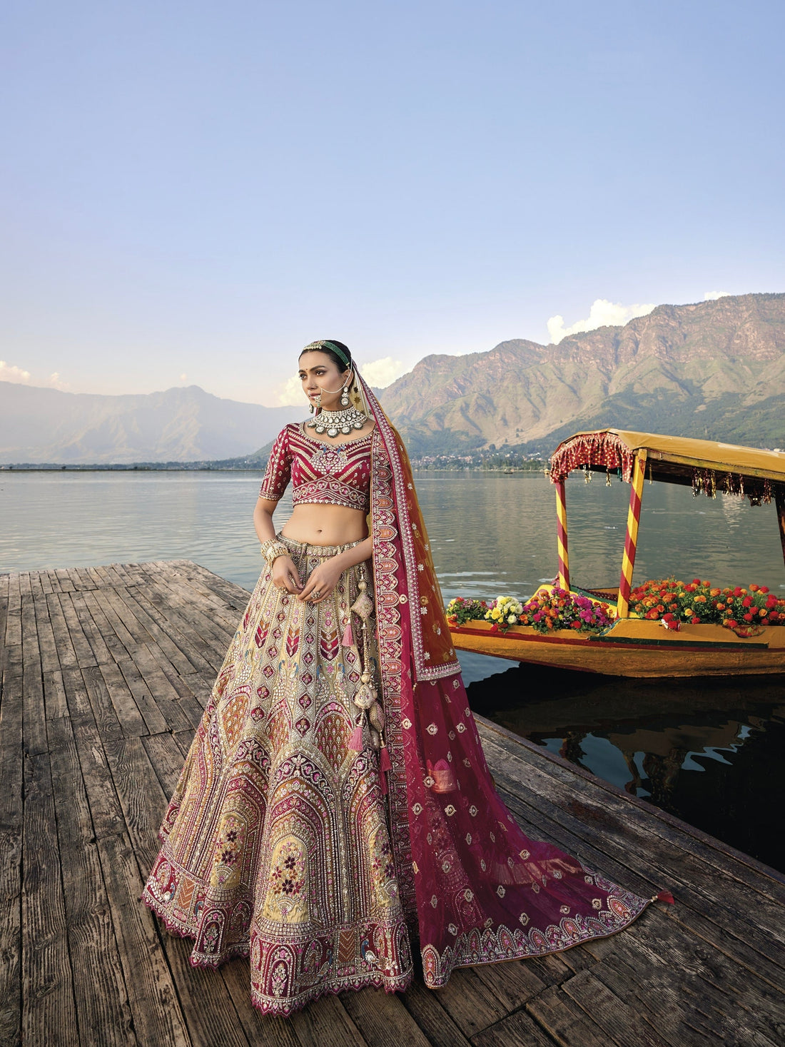 Elegant gold silk bridal lehenga with maroon embroidered blouse and dupatta.