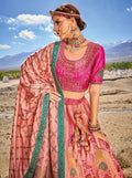 Woman wearing elegant pink Banarasi silk lehenga with embroidered blouse and georgette dupatta.