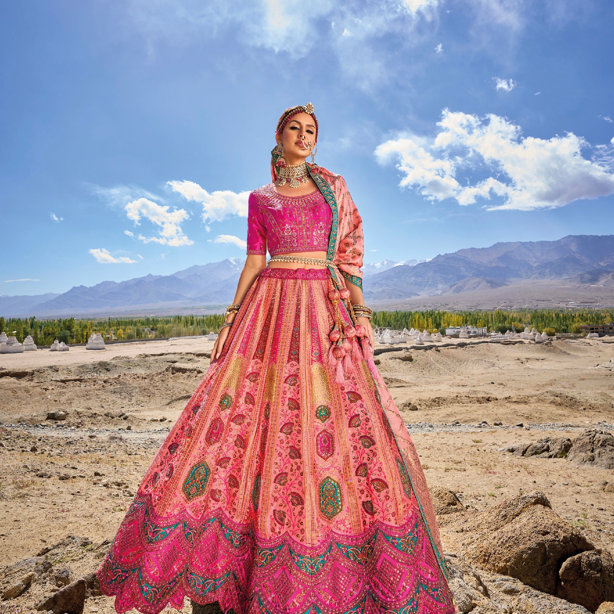 Woman wearing elegant pink Banarasi silk lehenga with embroidered blouse and georgette dupatta.