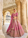 Elegant pink velvet lehenga with intricate embroidery and net dupatta.