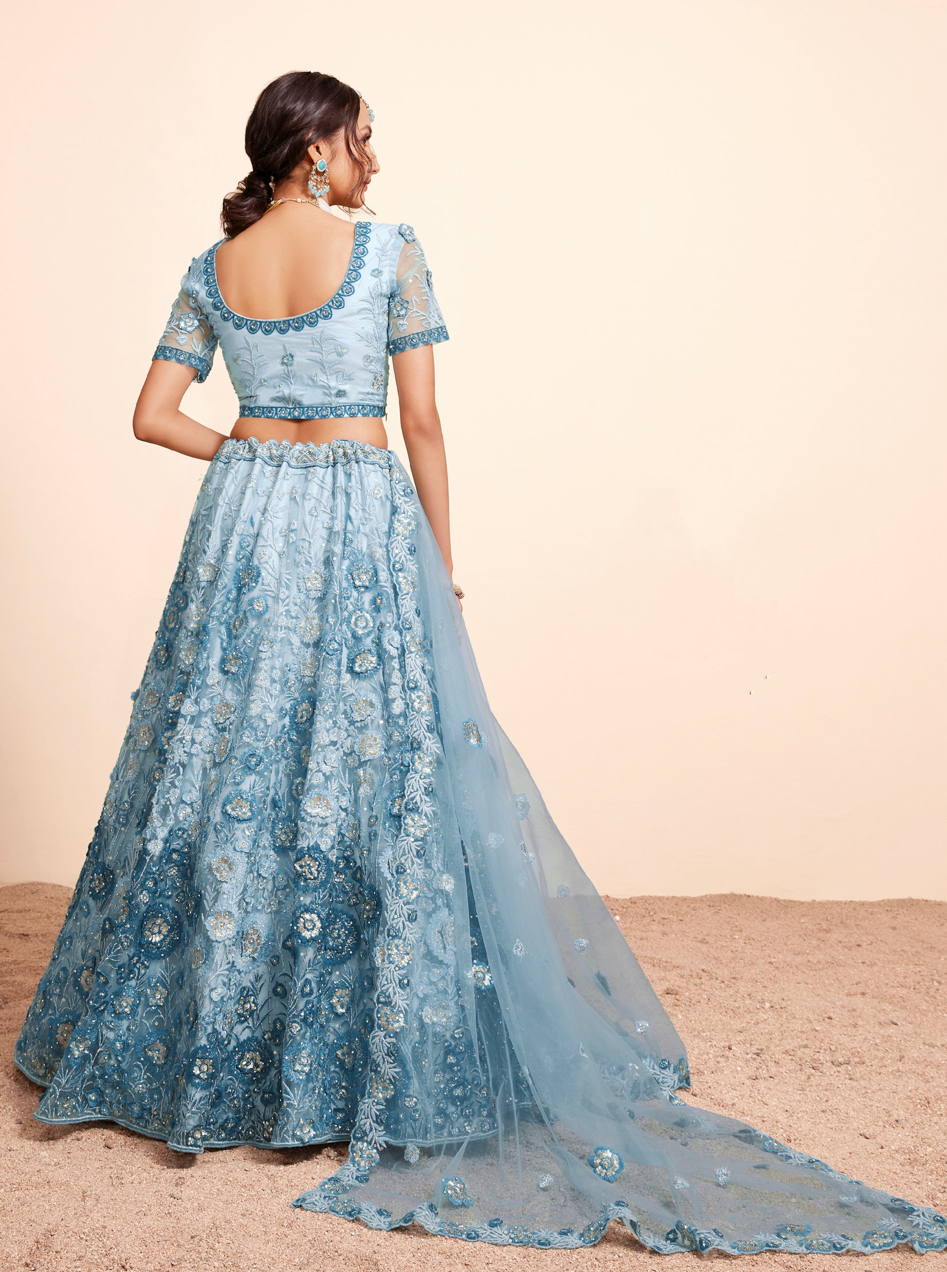 Elegant blue net lehenga with heavy embroidery and zarkan work.