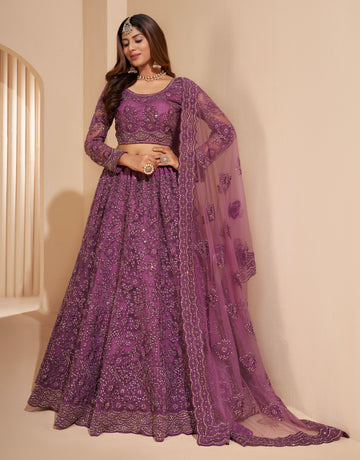 Elegant dark orchid net lehenga with silk inner and thread & cording embroidery.