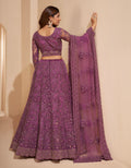 Elegant dark orchid net lehenga with silk inner and thread & cording embroidery.