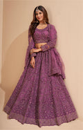 Elegant dark orchid net lehenga with silk inner and thread & cording embroidery.