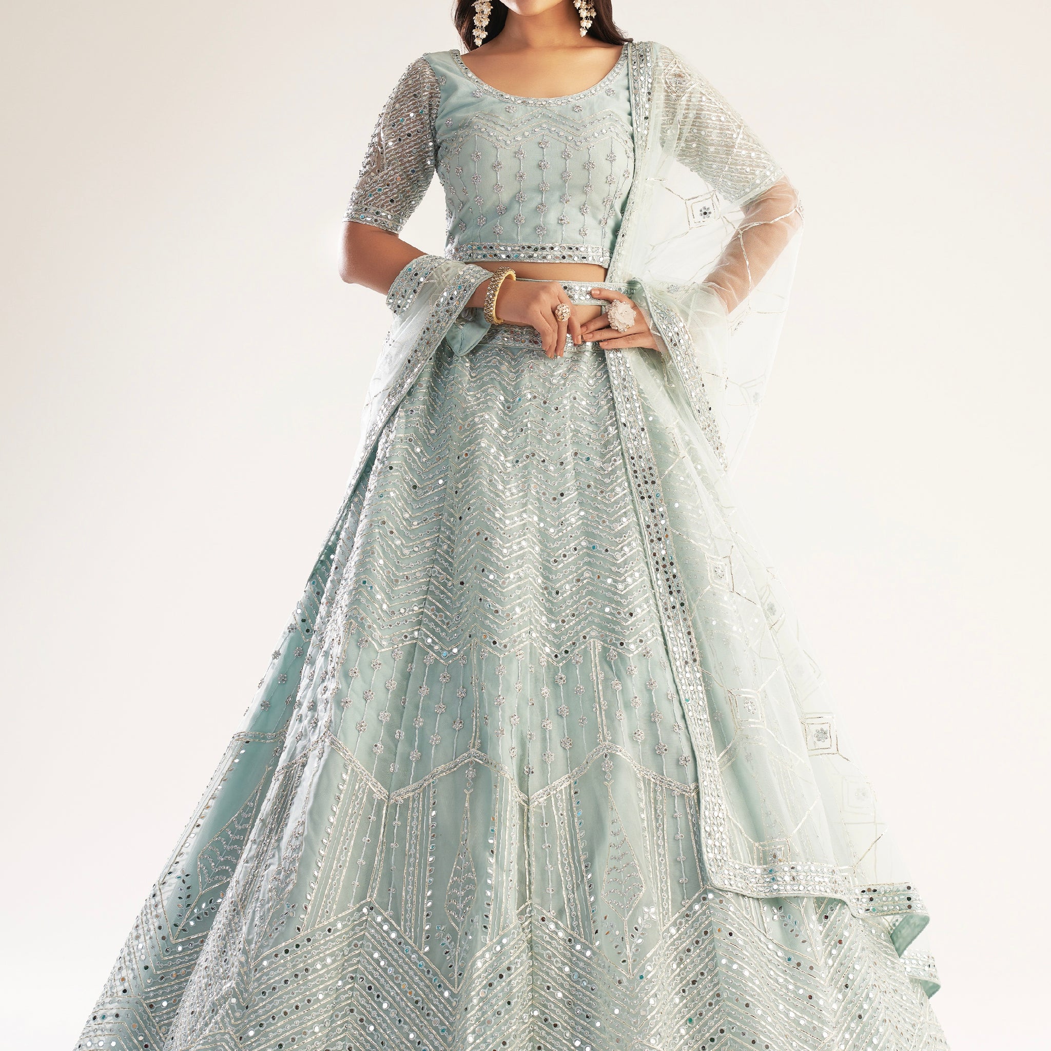 Elegant pastel ocean blue bridal lehenga with ribbon gota work and heavy zarkan embellishments.