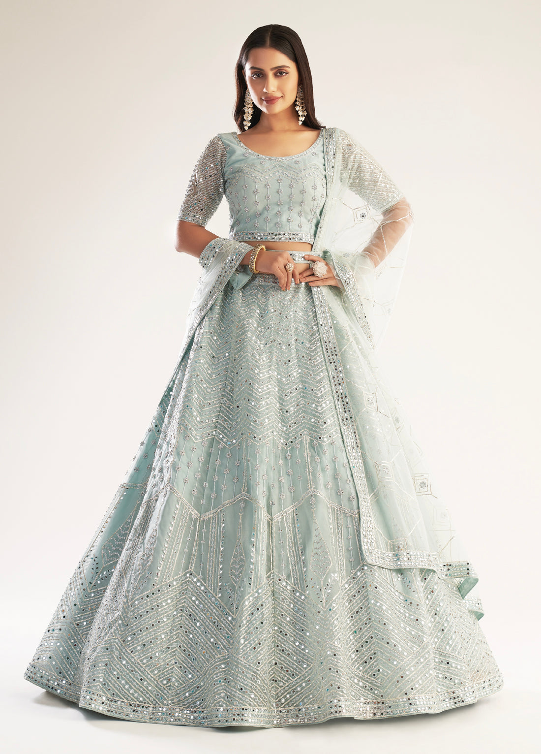 Elegant pastel ocean blue bridal lehenga with ribbon gota work and heavy zarkan embellishments.