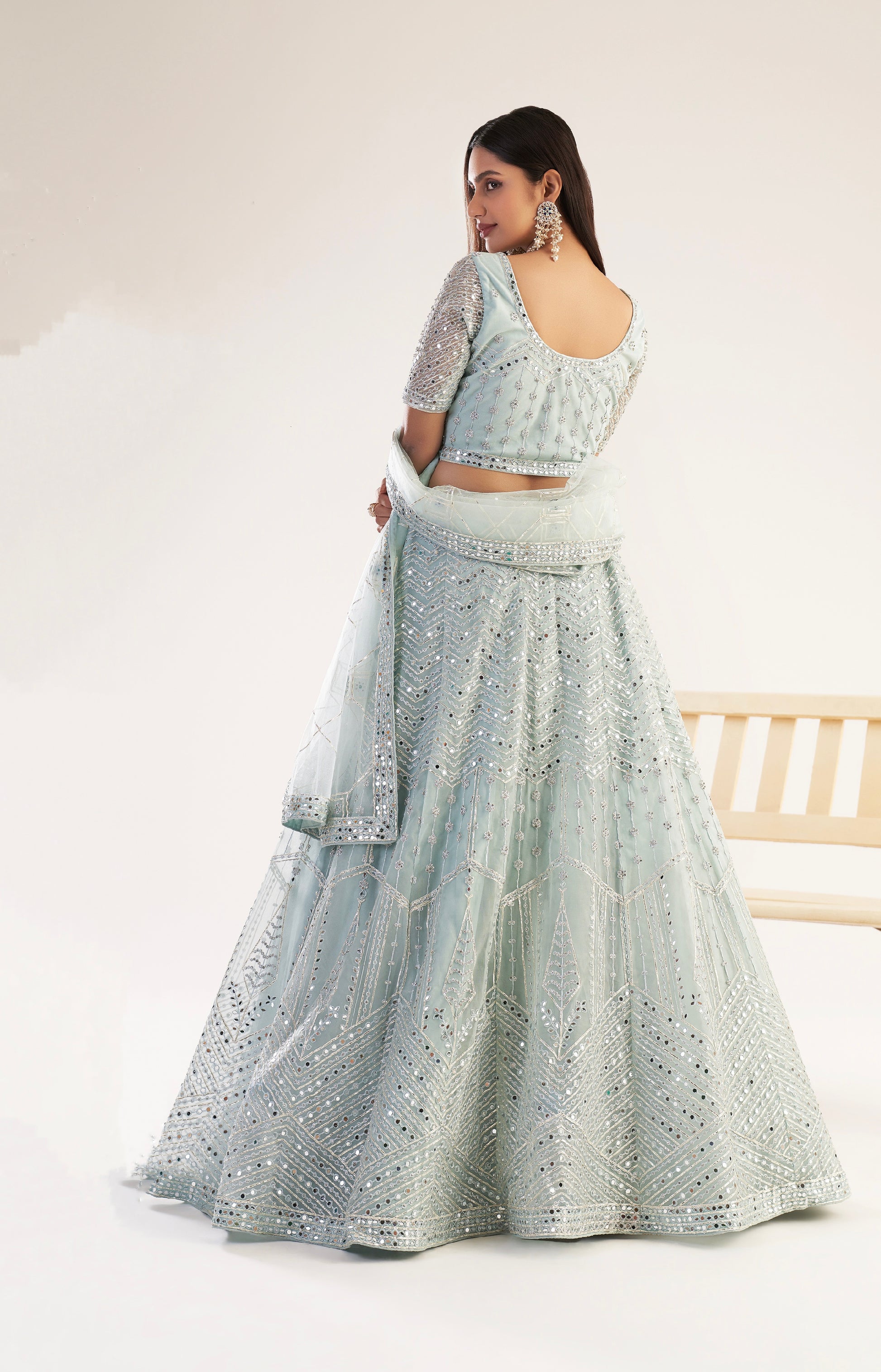 Elegant pastel ocean blue bridal lehenga with ribbon gota work and heavy zarkan embellishments.