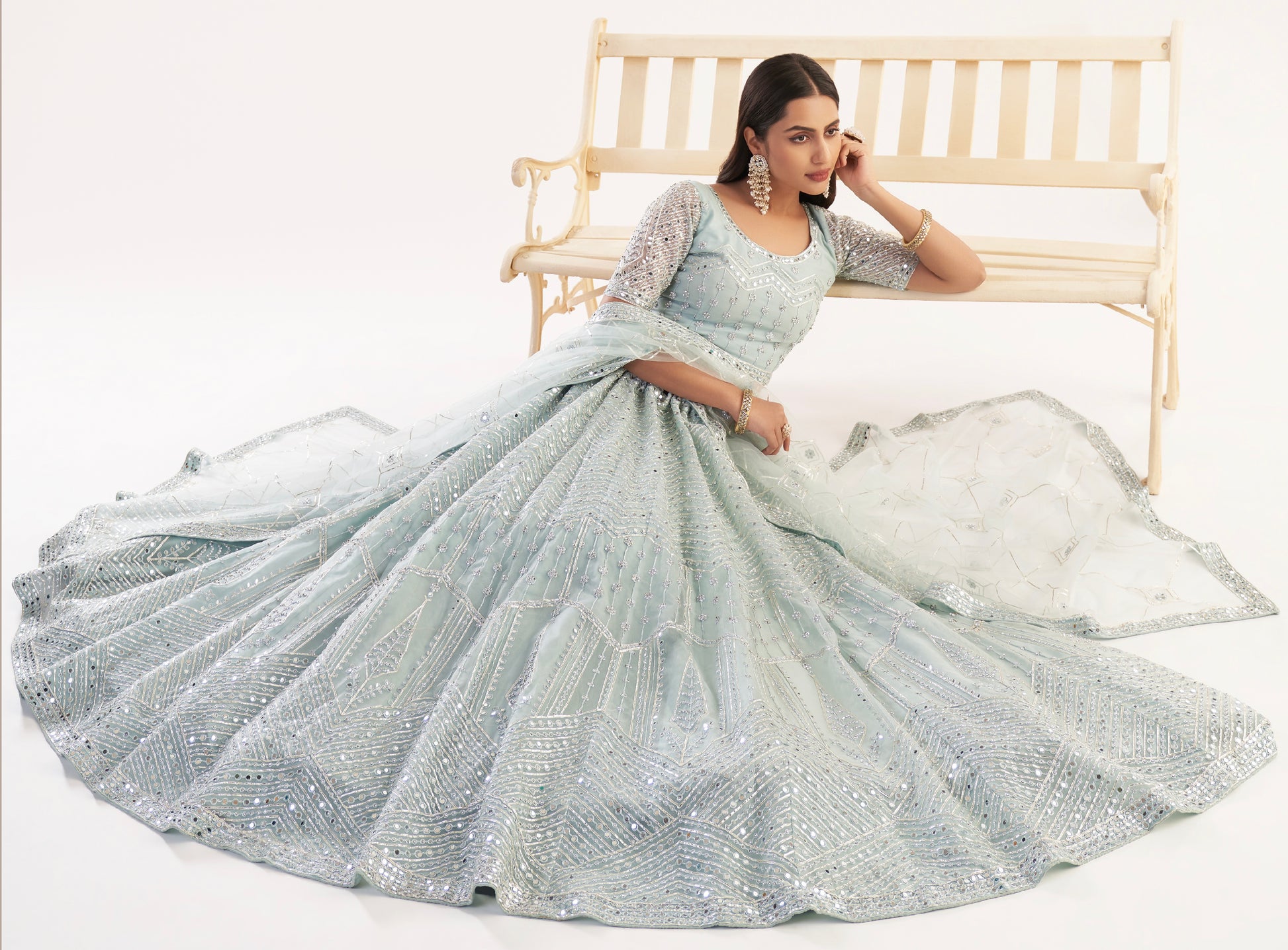 Elegant pastel ocean blue bridal lehenga with ribbon gota work and heavy zarkan embellishments.