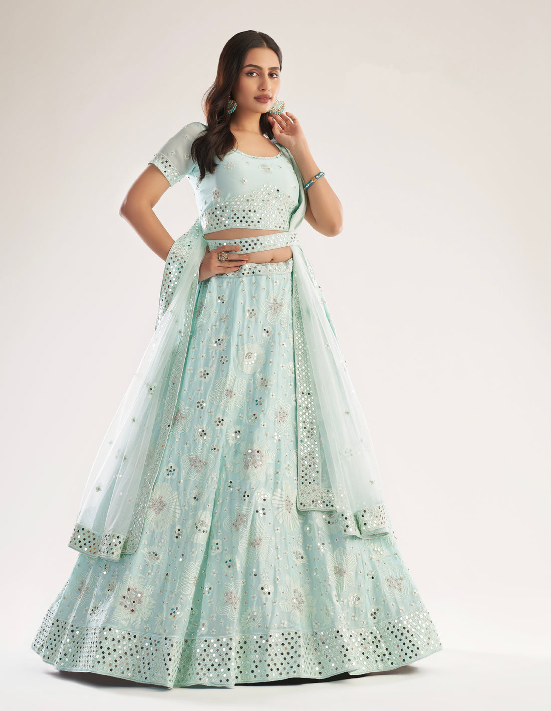 Elegant sea green bridal lehenga with heavy thread, zari embroidery, zarkan, and mirror work.