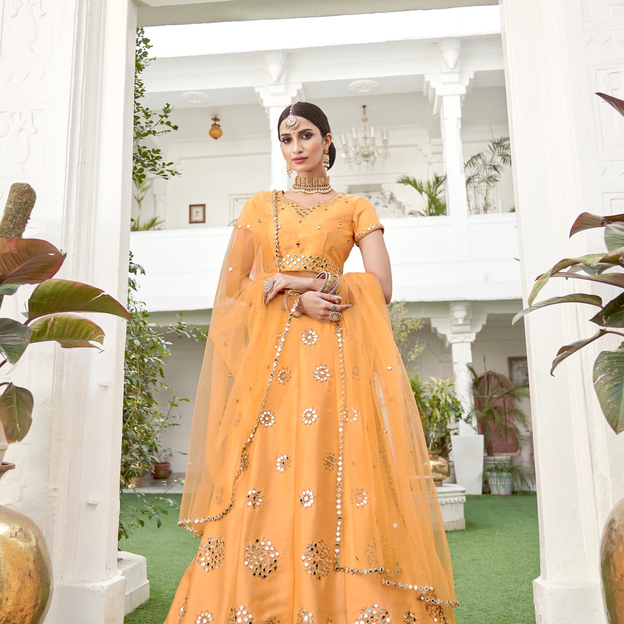 Mustard yellow lehenga choli with mirror work and dupatta