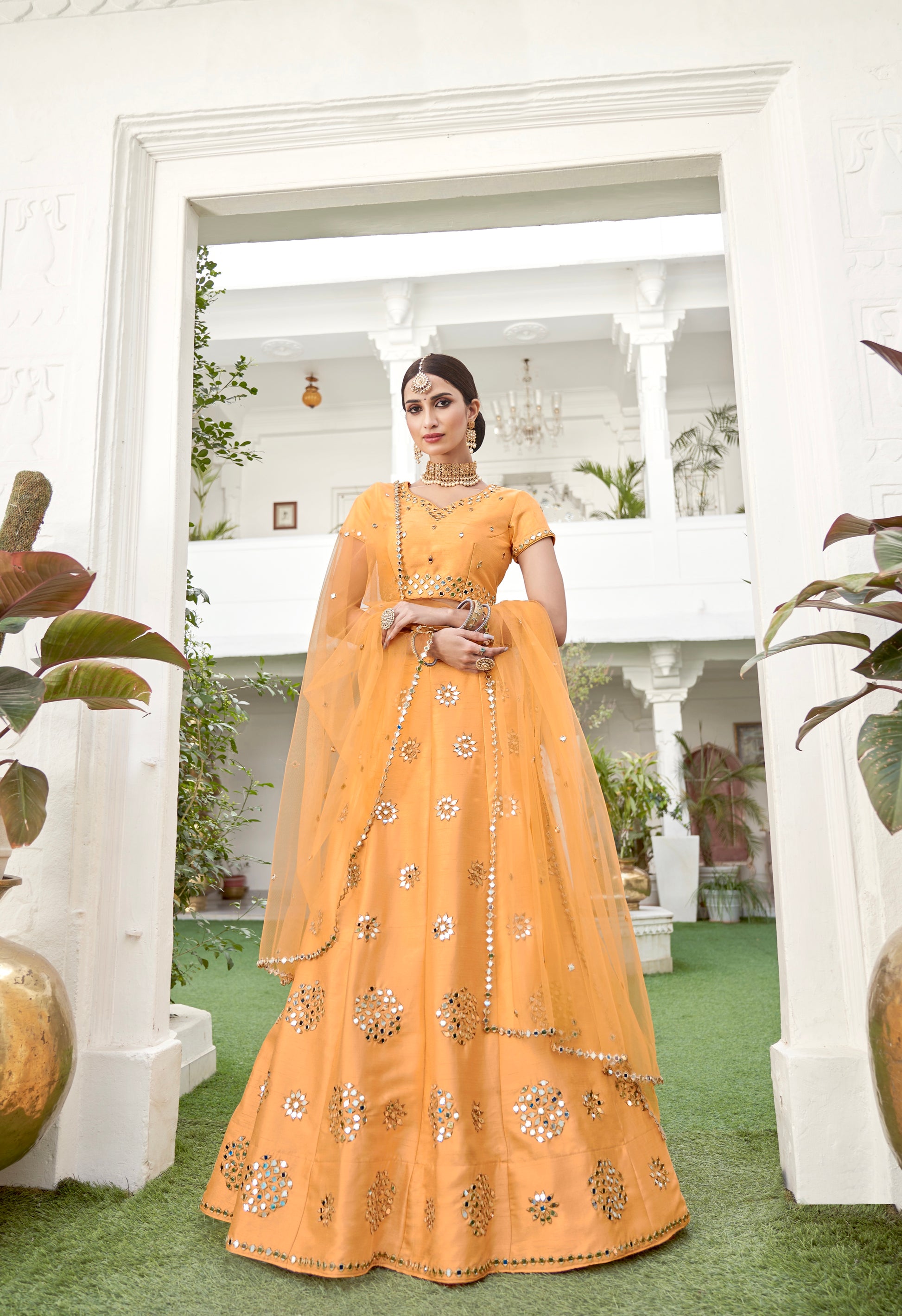 Mustard yellow lehenga choli with mirror work and dupatta