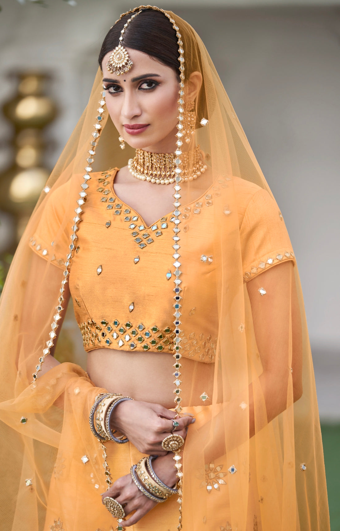 Mustard yellow lehenga choli with mirror work and dupatta