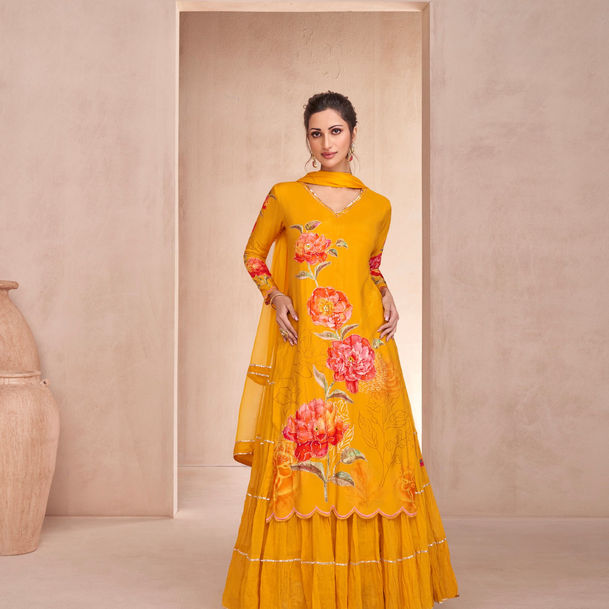 Yellow Muslin Anarkali with hand embellishments and Nazmeen dupatta.