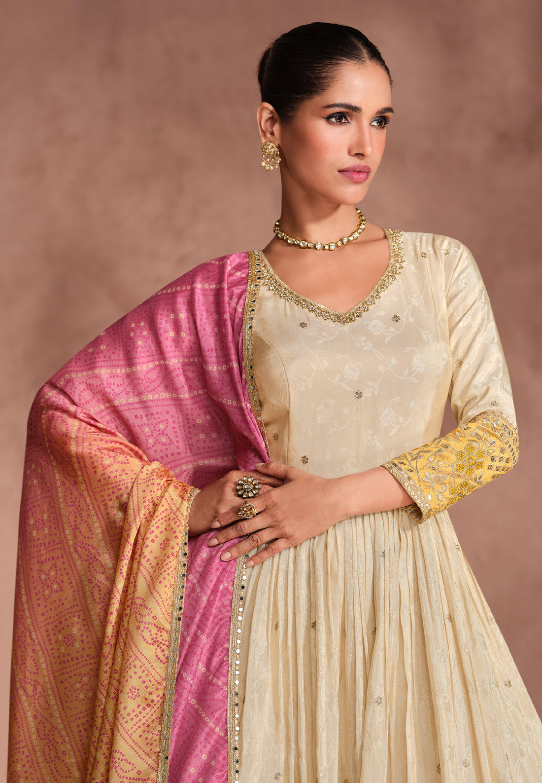 Cream Anarkali Suit with Golden Embroidery and Pink Bandhani Dupatta