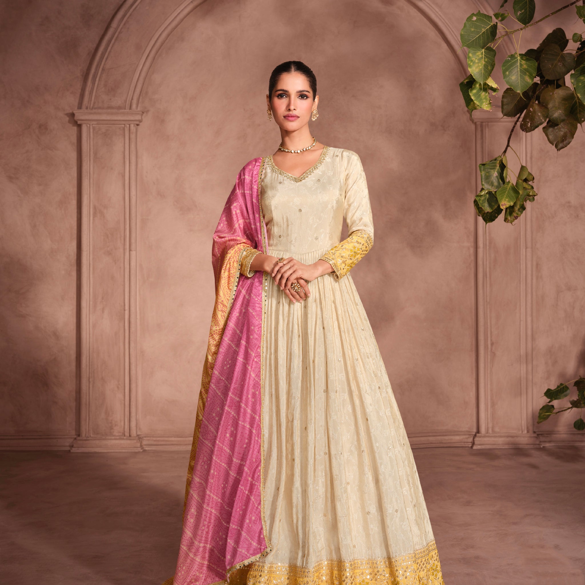 Cream Anarkali Suit with Golden Embroidery and Pink Bandhani Dupatta