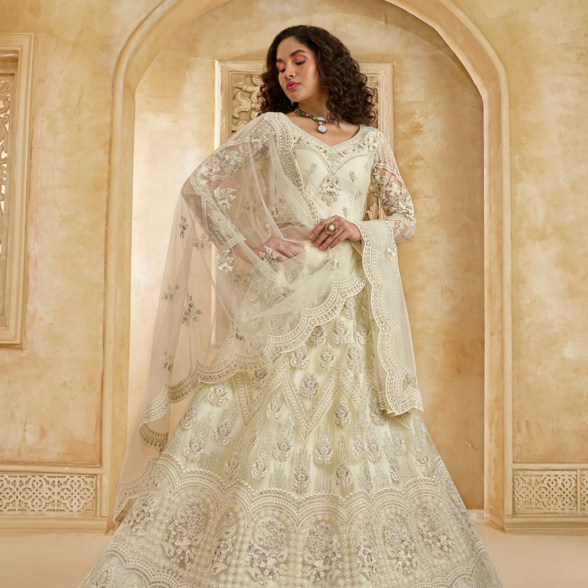 Ivory Net Lehenga Choli with Heavy Embroidery & Stonework